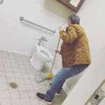 man mopping a bathroom