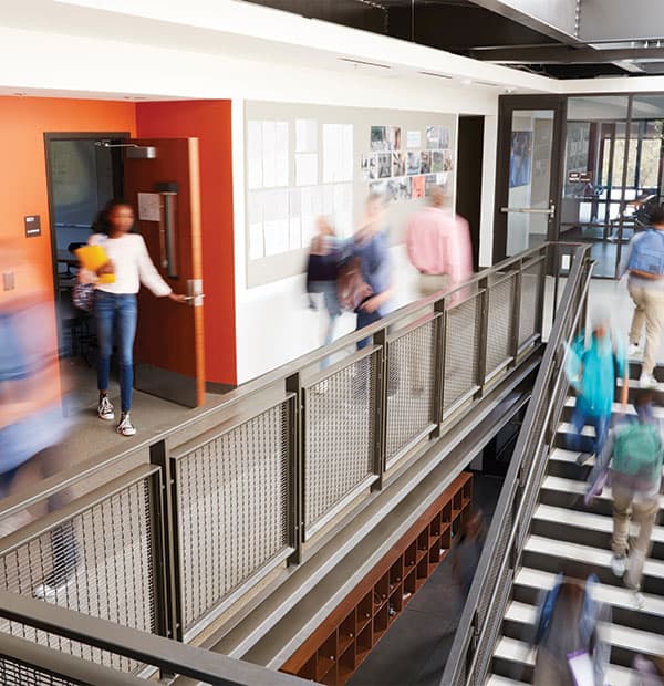 blurred motion of students and faculty walking in a school