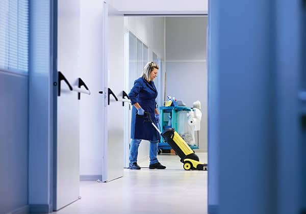 female employee cleaning floors