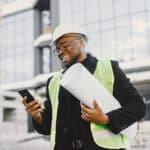 Black architect with project talk by phone