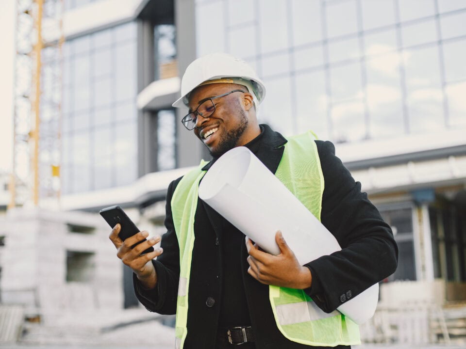 Black architect with project talk by phone