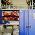 Industrial Storage Cabinet Containing Safety Helmets in Warehouse Environment