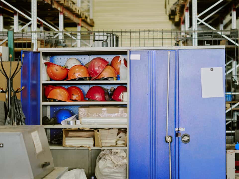 Industrial Storage Cabinet Containing Safety Helmets in Warehouse Environment